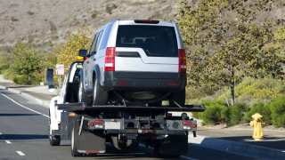 Silver SUV being towed